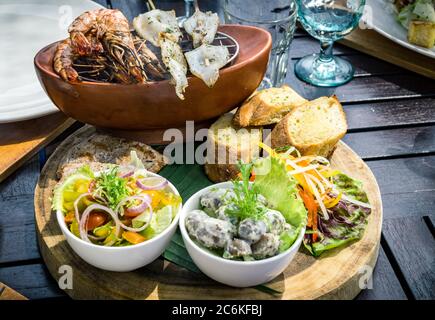 Traditional balinese sea food with salad and bread In Bali, Indonesia Stock Photo