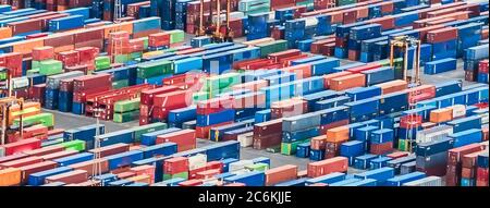 Texture made with an aerial view over shipping cargo containers stacked on a commercial port. Suitable to be used as background Stock Photo