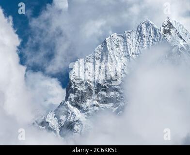 Telephoto shot of Thamserku 6608m mountain summit in the eastern Nepal Himalayas. Stock Photo
