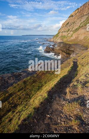 Rugged walkway along the cliffside near the Bogie Hole - Newcastle NSW. Dramatic coast and  rock fishing location in Australia's second oldest  city Stock Photo