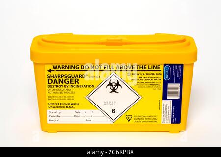 Sharps disposal bin. Container used to dispose of needles and other used sharp medical waste. Stock Photo