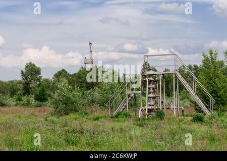 production gas well and drill rig mast Stock Photo