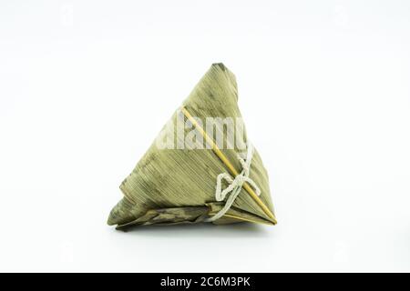 Closeup view of the zongzi, it is a traditional Chinese rice dish made of glutinous rice stuffed with different fillings and wrapped in reed leaves. Stock Photo