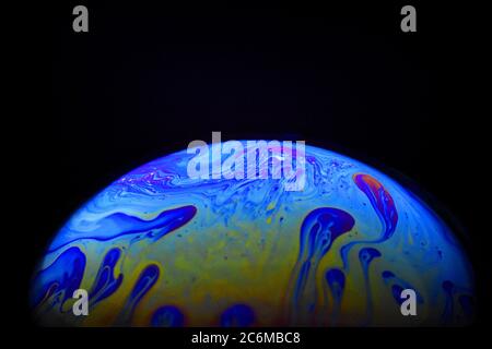 Light diffraction on soap bubble surface. Meteorological model. Stock Photo