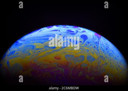 Light diffraction on soap bubble surface. Meteorological model. Stock Photo