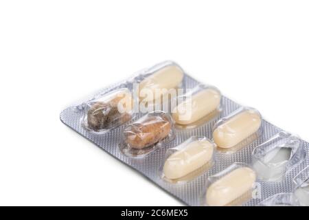 Strip of expired soft gel caplet medicine with mold on white background Stock Photo