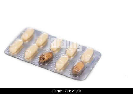 Strip of expired soft gel caplet medicine with mold on white background Stock Photo