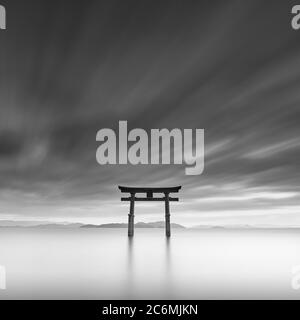 Long exposure shot of Shirahige shrine Torii gate at sunset at Lake Biwa, Shiga Prefecture, Japan Stock Photo