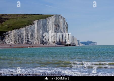 The Seven Sisters are a series of chalk cliffs by the English Channel. They form part of the South Downs in East Sussex, between the towns of Seaford Stock Photo