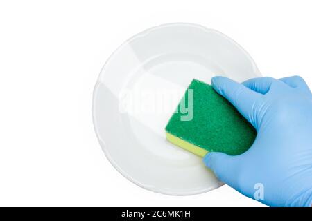 A hand in a blue rubber glove washes a white plate. Isolate on a white background. The view from the top Stock Photo