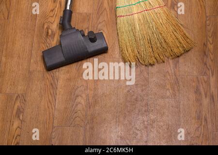 Vacuum cleaner brush and broom on the background of linoleum . The view from the top. Space for text or logo Stock Photo