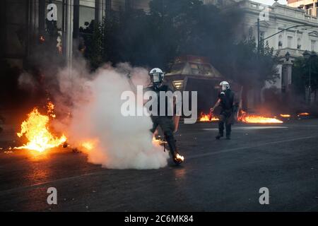 (200711) -- BEIJING, July 11, 2020 (Xinhua) -- Riot police officers respond to petrol bombs with tear gas during protests in Athens, Greece, July 9, 2020. The Greek parliament on Thursday passed a bill regulating public protests amid protests staged by opposition parties and labor unions.   Some 10,000 protesters marched in the center of the capital Athens on Thursday in three separate demonstrations organized by the radical left SYRIZA party, the umbrella union of civil servants ADEDY and the Greek Communist party KKE-affiliated PAME labor union. (Photo by Lefteris Partsalis/Xinhua) Stock Photo