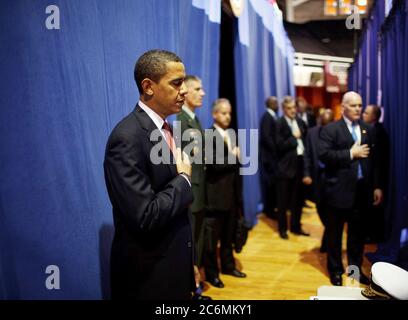 Before giving a policy speech on Iraq, President Barack Obama places his hand on his heart as the national anthem is played backstage  at the Field House, Camp Lejeune, North Carolina 2/27/09. Stock Photo