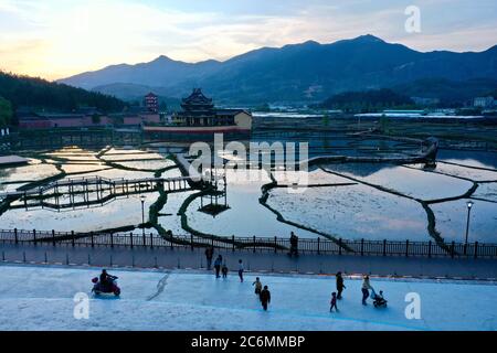 (200711) -- FUZHOU, July 11, 2020 (Xinhua) -- Aerial photo shows villagers and tourists spending their leisure time at sunset in the Carp Brook scenic area of Puyuan Village, Puyuan Township, Zhouning County, southeast China's Fujian Province, April 17, 2020. At the first glance, Puyuan Village appears no difference from other historical villages in China. But it's the carp fish in a local creek, known as the Carp Brook, that make the village special. Puyuan village covers an area of 9.2 square kilometers and has a population of about 6,200. Originated from the Ziyun Mountain, several str Stock Photo