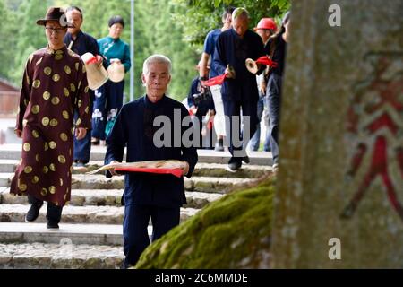 (200711) -- FUZHOU, July 11, 2020 (Xinhua) -- Villagers demonstrate a funeral ritual for deceased carp in Puyuan Village, Puyuan Township, Zhouning County, southeast China's Fujian Province, July 4, 2020.  At the first glance, Puyuan Village appears no difference from other historical villages in China. But it's the carp fish in a local creek, known as the Carp Brook, that make the village special.     Puyuan village covers an area of 9.2 square kilometers and has a population of about 6,200. Originated from the Ziyun Mountain, several streams converge into the 3,000-meter-long Carp Brook, wit Stock Photo