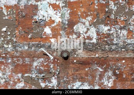 A full frame photograph of an exterior wall with peeling paper and paint Stock Photo