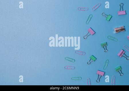 Pins and paper clips collection on blue background Stock Photo