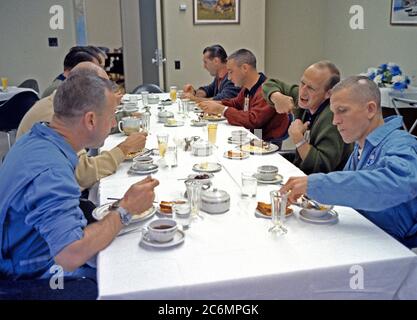 (4 Dec. 1965) --- Fellow astronauts join the Gemini-7 prime crew for breakfast in the Manned Spacecraft Operations Building, Merritt Island, on the day of the Gemini-7 launch. Clockwise around the table, starting lower left, are astronauts James A. Lovell Jr., Gemini-7 prime crew pilot; Walter M. Schirra Jr., Gemini-6 prime crew command pilot; Donald K. Slayton, MSC assistant director for Flight Crew Operations; Virgil I. Grissom, Gemini-6 backup crew command pilot; Charles Conrad Jr., Gemini-5 prime crew pilot; and Frank Borman, Gemini-7 prime crew command pilot. Stock Photo