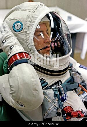 (4 Dec. 1965) --- Astronaut James A. Lovell Jr., pilot of the Gemini-7 spaceflight, relaxes in the suiting up trailer at Launch Complex 16, during the Gemini-7 prelaunch countdown at Cape Kennedy, Florida. Lovell wears the new lightweight spacesuit specially designed for long-duration flights. Stock Photo