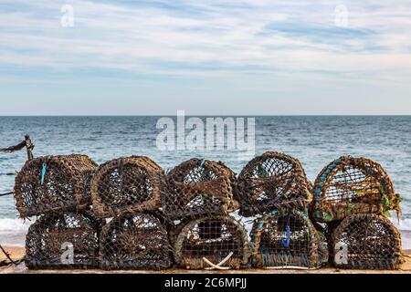 Lobster pots lined up on a beach, on the Isle of Wight Stock Photo
