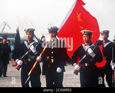 Members of a Chinese color guard armed with Type 56 assault rifles march in review during the first visit by US Navy ships to China in 40 years. Stock Photo
