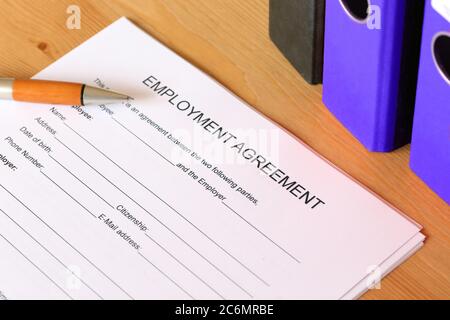 Symbol image: Blank form of an employment agreement on a desk Stock Photo