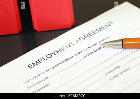 Symbol image: Blank form of an employment agreement on a desk Stock Photo