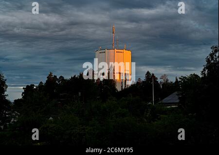 water tower in evening light in orange on it Stock Photo