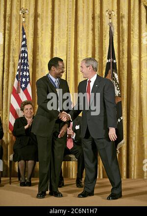 President George W. Bush shakes hands with Dr. Benjamin Carson Thursday, June 19, 2008, after presenting him with the 2008 Presidential Medal of Freedom during ceremonies in the East Room of the White House.