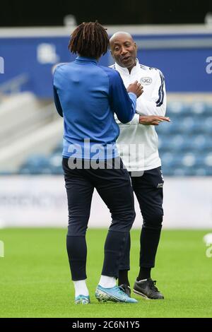 Eberechi Eze of QPR and Head of Coaching Chris Ramsey share a joke during the EFL Sky Bet Championship match between Queens Park Rangers and Fulham at The Kiyan Prince Foundation Stadium, London, England on 30 June 2020. Photo by Ken Sparks. Editorial use only, license required for commercial use. No use in betting, games or a single club/league/player publications. Stock Photo