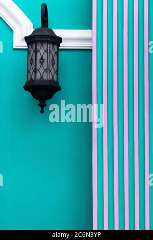 black classic lamp light on blue pink colorful cement wall painted architecture background Stock Photo