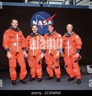 (24 May 1999) --- From the left, astronauts Steven L. Smith, John M. Grunsfeld, C. Michael Foale and Claude Nicollier, all mission specialists, pose for an informal portrait.  The STS-103 crew members are wearing training versions of the shuttle partial-pressure launch and entry space garments. Stock Photo