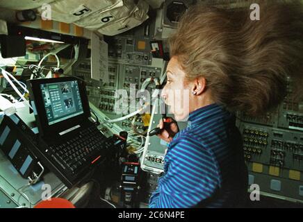 (12-22 January 1997) --- Astronaut Marsha S. Ivins, mission specialist, looks at digital still photo imagery on a lap top computer on the Space Shuttle Atlantis' aft flight deck while communicating with students on Earth. Her activity is all part of the once-a-year shuttle participation in an educational endeavor called KidSat. The KidSat project allows students the opportunity to interact with the astronauts' real-time observations and photography of geographic points of interest. The Electronic Still Camera (ESC), which was handled largely by Ivins, can be seen near the computer. Stock Photo