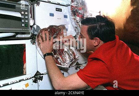 (11-21 Feb. 1997) --- On Discovery's middeck, astronaut Scott J. Horowitz, STS-82 pilot, works on one of the multi-layer insulation (MLI) patches to be used by two crew mates on an upcoming space walk to repair worn insulation on the Hubble Space Telescope (HST). Stock Photo