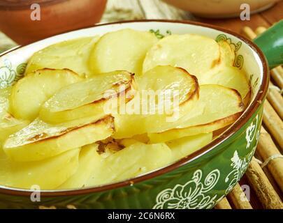 Scalloped Potato And Smoked Fish Pot, Smoked haddock and potato gratin Stock Photo