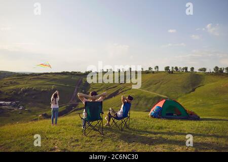 Traveling family resting in camp in summer nature Stock Photo