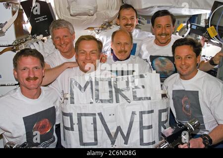 (11-21 Feb. 1997) --- The STS-82 crew poses for a traditional in-flight portrait following completion of five Extravehicular Activities (EVA) to service the Hubble Space Telescope (HST).  Both the sign held by the crew and the assortment of apparel pay tribute to the HST and its team of ground supporters.  In front, left to right, are astronauts Joseph R. Tanner, Mark C. Lee and Gregory J. Harbaugh.  Behind them, left to right, are astronauts Steven A. Hawley, Kenneth D. Bowersox and Scott J. Horowitz.  At the very back is astronaut Steven L. Smith.  Each astronaut is wearing a shirt bearing a Stock Photo