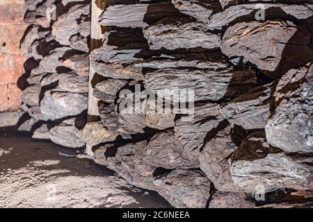 Storage of dry wooden coal, charcoal is piled and ready for ussage. Stock Photo