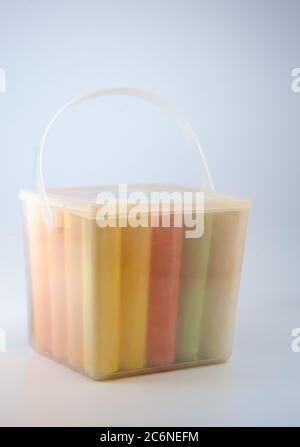 Colorful chalks in plastic bucket isolated on white background. Close-up, layout. Place for text and labels. Set children's large chalk for drawing on Stock Photo