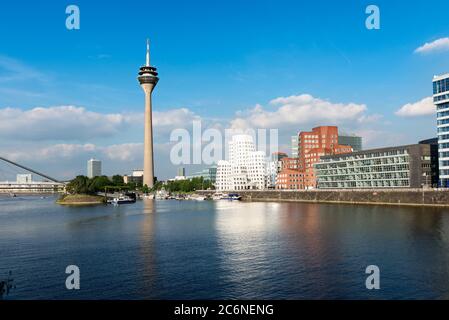 Düsseldorf's Media Harbor (Medienhafen) with Rheinturm tower and modern architecture by Frank O. Gehry. Stock Photo