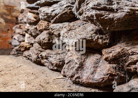 Storage of dry wooden coal, charcoal is piled and ready for ussage. Stock Photo