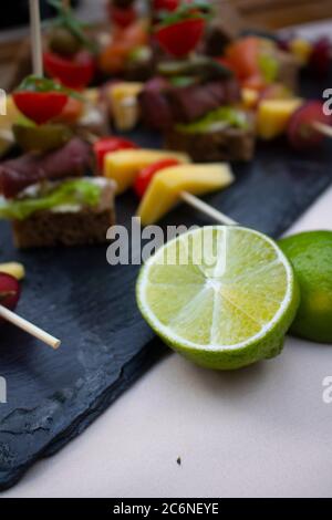 Lime Close up shot cheese on black board, vegan snacks Stock Photo