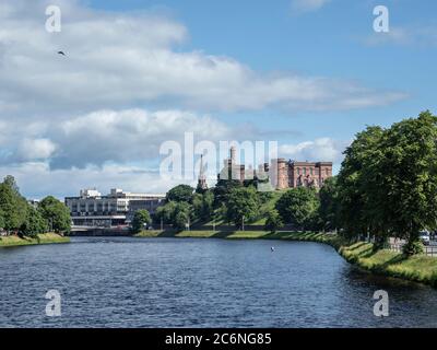 Inverness Castle from the River Ness, Inverness, Highland, Scotland. Picture taken from Infirmary Bridge also shows person wading and fishing. Stock Photo