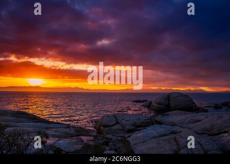 View of a cloudy sunrise from Boulders beach with a view of False Bay, Simon's Town , Cape Town, South Africa Stock Photo