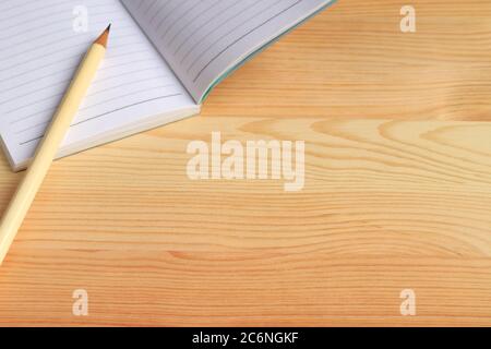Blank Lined Notebook with a Pencil Isolated on Wooden Table Stock Photo