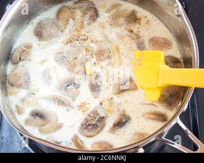 Grind the puree soup ingredients. Mushrooms and potatoes. Cooking cream soup. Stock Photo