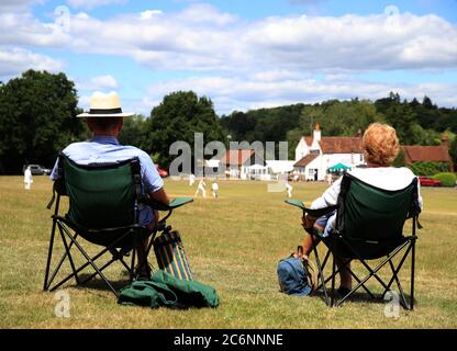 Spectators take in a village cricket match at Tilford Cricket Club, Farnham. Stock Photo