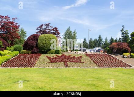 Vancouver, Canada - 02 June 2019: The Canadian National flag with maple leave made of flower at the Canadian side in the  Canada - US Peace Arch borde Stock Photo