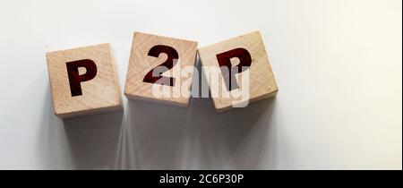 P2P abbreviation written in wooden blocks. Peer to peer business concept Stock Photo