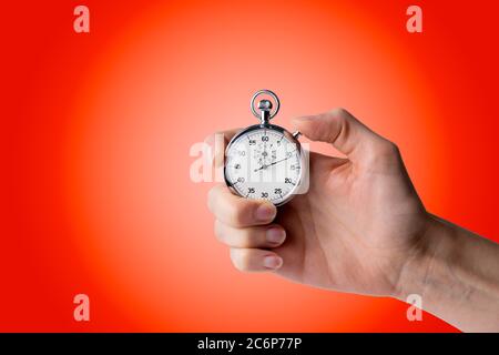 stopwatch hold in hand, button pressed Stock Photo